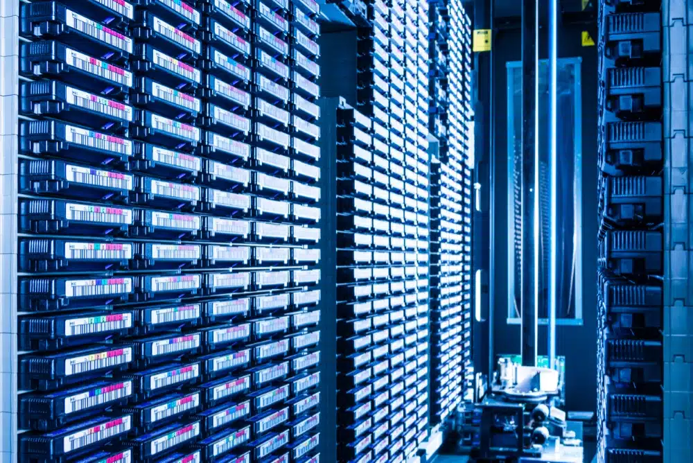 Enterprise tape storage library rack showing LTO tape cartridges in robotic library